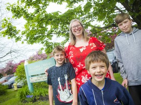 Tanya Hein and her children, Joshua Hein, 12, Spencer Hein, 10, and Elliot Hein, 6, in front of A. Lorne Cassidy Elementary School.