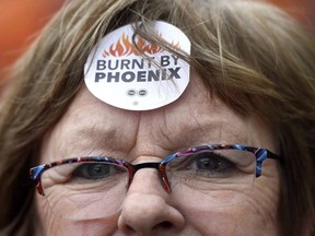 Shirley Taylor wears a "Burnt by Phoenix" sticker during a 2018 rally against the Phoenix payroll system outside the offices of the Treasury Board of Canada.