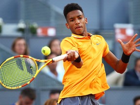 Felix Auger-Aliassime plays a forehand against Denis Shapovalov during day two of the Mutua Madrid Open at La Caja Magica on May 05, 2019 in Madrid, Spain.