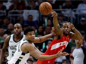 Kawhi Leonard of the Toronto Raptors handles the ball while being guarded by Giannis Antetokounmpo of the Milwaukee Bucks in the third quarter during Game 5 of the Eastern Conference Finals of the 2019 NBA Playoffs at the Fiserv Forum on May 23, 2019 in Milwaukee.