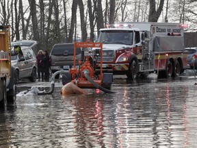 Bayview Drive in flooded Constance Bay was busy Tuesday evening as people were either loading up to go or getting gas and other supplies to stay following a voluntary evacuation order for 150 homes on the streets from the city.