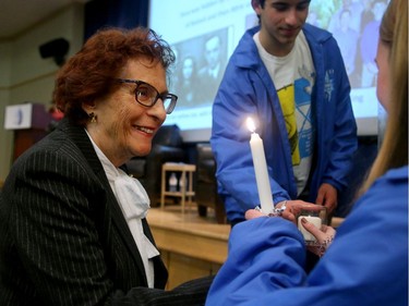 Holocaust survivor Dora Lipski lights a candle during the annual Holocaust Remembrance Day service at the Soloway Jewish Community Centre Wednesday evening, which remembers the six million killed under the Nazi regime during World War II.  Ms. Lipski was born in Belgium in 1934 and hidden by the Red Cross in small towns until liberation in 1945.  The event, which featured an interview with another Holocaust survivor,  Elly Gotz, was attended by almost 500 people, who also observed remembrance for the most recent anti-Semitic attack in a synagogue in California over the weekend, which left one dead and three injured.  Julie Oliver/Postmedia