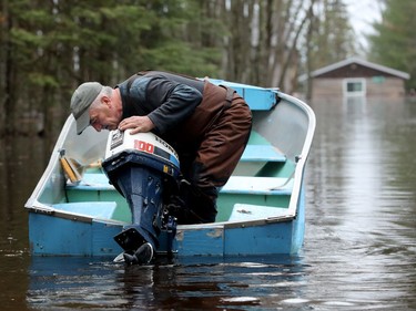 Richard Bergeron returns by boat to feed his cats that are staying in his garage on higher ground on Edgewater Trail — a small enclave of waterfront homes in the Whitewater municipality about 20 minutes east of Pembroke. His house is fully under water. Of the 11 homes on this street, nine are now abandoned.
