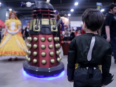 A young Batman stops dead in his tracks as one of Dr. Who's Daleks makes its way through the EY Centre.