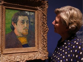 Exhibit curator Cornelia Homburg looks at a Gaugin painting - Self-portrait dedicated to Carrière, oil on coarse fabric - in the Gauguin Portraits exhibition at the National Gallery,  May 22, 2019.