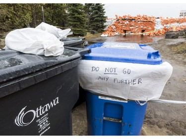 A homemade sign by the sandbags reinforcing the concrete wall of the Britannia berm against flood waters on Jamieson Street in Ottawa on May 1, 2019. Errol McGihon/Postmedia