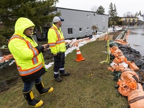 City officials monitor the Britannia berm against flood waters in Ottawa on May 1, 2019.