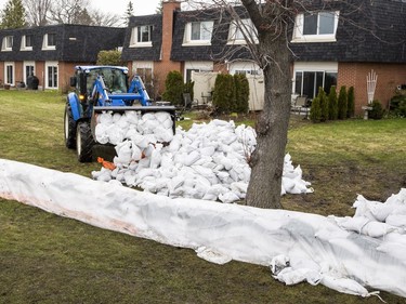 Sandbags are delivered near homes close to the Britannia berm to combat against flood waters in Ottawa on May 1, 2019.
