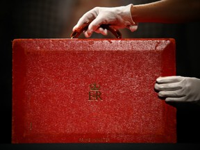 A member of staff poses with a 'Prime Ministerial Red Morocco Dispatch Box' during a press preview at Christie's auction house on December 15, 2015 in London, England. Due to form part of the 'Mrs Thatcher - Property from the Collection of The Right Honourable The Baroness Thatcher of Kesteven LG, OM, FRS' sale on December 15th, it is expected to fetch between 3,000-5,000 GBP 4,600-7,600 USD - 4,300-7,000 EUR.