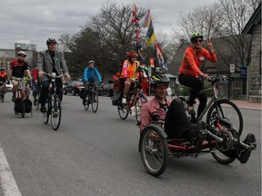 A group of cyclists, including Chris Bradshaw's daughter Karen Bradshaw (right, orange jacket) take part in a "critical mass" cycling trip down Richmond Rd. in celebration of Chris's life. Jacob Hoytema / Postmedia