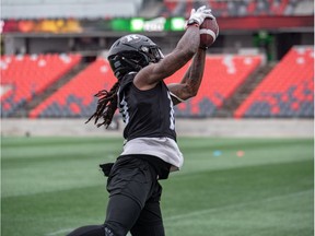 Troy Stoudermire reaches for a pass thrown his way during Redblacks practice on Tuesday.