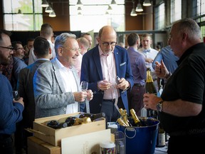 Tim Hutchinson and his husband Andrew Ember get a glass of wine.