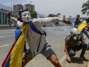 Anti-government protesters clash with security forces in the surroundings of La Carlota military base in Caracas, Venezuela, during the commemoration of May Day.