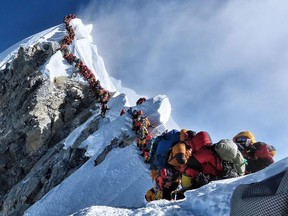 In this file handout photo taken on May 22, 2019 and released by climber Nirmal Purja's Project Possible expedition shows heavy traffic of mountain climbers lining up to stand at the summit of Mount Everest.