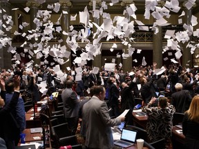 Members of the Missouri House throw papers in the air to mark the end of the legislative session, at the State Capitol in Jefferson City, Mo., on Friday, May 16, 2019. State lawmakers passed a bill here to ban abortions after a fetal heartbeat is detected, the latest in a national flurry of anti-abortion measures intended to mount direct challenges to Roe v. Wade.