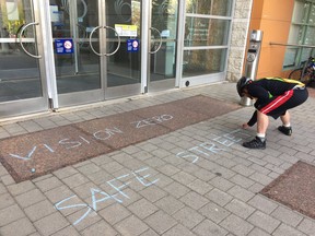 Chalk drawings and flowers rest at the scene of the hit and run where a cyclist had died on Laurier Avenue last week.