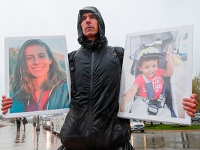 Tarek Milleron holds the photographs of victims in the Ethiopian Airlines Flight 302 Boeing plane crash during a protest outside Boeing's annual shareholders meeting in April in Chicago, Illinois.