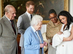 In this image made available by SussexRoyal on Wednesday May 8, 2019, Britain's Prince Harry and Meghan, Duchess of Sussex, joined by her mother Doria Ragland, show their new son to Queen Elizabeth II and Prince Philip at Windsor Castle, Windsor, England. Prince Harry and Meghan have named their son Archie Harrison Mountbatten-Windsor.