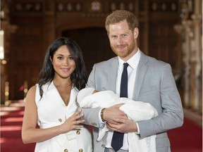 Britain's Prince Harry and Meghan, Duchess of Sussex, during a photocall with their newborn son, in St George's Hall at Windsor Castle, Windsor, south England, Wednesday