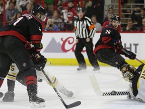 Boston Bruins goalie Tuukka Rask, right, of Finland, stops the puck while Carolina Hurricanes' Nino Niederreiter, of Switzerland, looks to score during the second period in Game 3 of the NHL hockey Stanley Cup Eastern Conference final series in Raleigh, N.C., Tuesday.