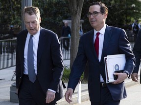 United States Trade Representative Robert Lighthizer, left, and Treasury Secretary Steven Mnuchin walk on Pennsylvania Avenue back to the White House on Thursday, May 9, 2019, in Washington. A top Trump administration cabinet member says the end of punishing steel and aluminium tariffs on Canada and Mexico is close at hand.