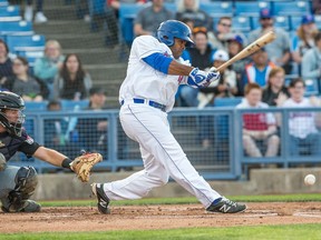 An Ottawa Champions player pounds the baseball into the dirt near home plate in a 2016 home game against the New Jersey Jackals.