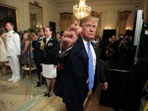 President Donald Trump waves as he leaves the East Room during a celebration of military mothers with first lady Melania Trump at the White House in Washington, Friday, May 10, 2019.