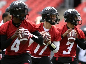 Ottawa Redblacks quarterbacks Dominique Davis (4), Danny Collins (17) and Jonathon Jennings (3) participate in the team's training camp in Ottawa on Sunday, May 19, 2019.