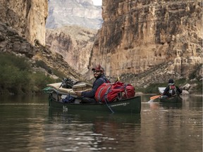 This December 2018 photo released by Fin and Fur Films shows guide Austin Alvarado paddling through Boquillas Canyon in Big Bend National Park, Texas, with filmmakers and wildlife photographers near the U.S.-Mexico border. The new documentary, "The River and The Wall," released Friday, May 3, 2019, examines the diverse wildlife and landscape of the Rio Grande along the U.S.-Mexico border. (Fin and Fur Films via AP) ORG XMIT: LA604