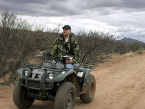 FILE - In this Feb. 18, 2005, file photo, Michael King, a member of American Border Patrol, a citizen watchdog group that posts images from the U.S.-Mexico border to draw attention to illegal immigration, rides along the U.S.-Mexico border ear Cochise County, Ariz. Throughout U.S. history, private, armed groups have been hired or appointed themselves to police the U.S-Mexico border for a variety of reason, ranging from preventing Chinese immigrants from crossing over illegally to preventing runaway slaves from fleeing.
