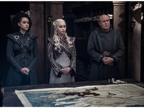 This image released by HBO shows from left, Nathalie Emmanuel, Emilia Clarke and Conleth Hill in a scene from "Game of Thrones," that aired Sunday, May 5, 2019. "Game of Thrones" fans got a taste of the modern world as the fictional series winds down to its final episodes. Eagle-eyed viewers Sunday spotted a takeout coffee cup on the table during a celebration in which the actors drank from goblets and horns. Daenerys and Jon did not react to the out of place cup.