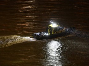 A rescue boat searches for victims after a tourist boat crashed with another ship late Wednesday, May 29, 2019. The boat capsized and sunk in the Danube River Wednesday evening, in Budapest, with dozens of people on board, Hungarian media reported.