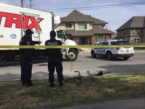 A cyclist was in critical condition after she was struck by a delivery truck and trapped underneath its wheels near Parkdale Avenue and Ruskin Street Tuesday morning.