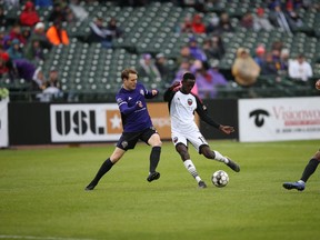 Mour Samb of Ottawa Fury FC tries to protect the ball against defensive pressure by Magnus Rasmussen of Louisville City FC during a United Soccer League Championship match at Louisville on Saturday, April 20, 2019. Louisville won 1-0. Photo by Louisville City FC / USL Championship