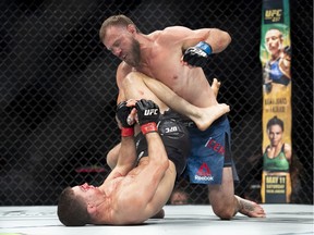 Donald Cerrone, left, punches Al Iaquinta in the lightweight bout during UFC Fight Night in Ottawa on Saturda.