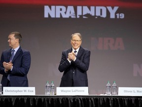 Wayne LaPierre, chief executive officer of the National Rifle Association (NRA) ( right) and Chris Cox, chief lobbyist of the NRA, stand near an empty seat reserved for retired U.S. Marine Corps Lieutenant Colonel Oliver North, president of the NRA, at the NRA annual meeting of members in Indianapolis on April 27, 2019.