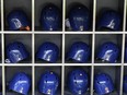 This Sept. 28, 2018 photo shows batting helmets in a rack before a Major League Baseball game in New York. According to study published Friday, May 24, 2019, NFL players may be more likely to die from brain diseases and heart problems than MLB players but the reasons are unclear.