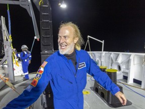 In this photo provided by Atlantic Productions for Discovery Channel, Victor Vescovo emerges from his submersible 'Limiting Factor' after a successful dive to the deepest known point in the Mariana Trench, April 28, 2019. Vescovo, a businessman and amateur pilot, has also traversed the highest peaks of mountains, including Mount Everest.