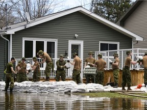 Soldiers work to hold back floodwaters on the Ottawa River in Cumberland. Ontario on Tuesday, April 30, 2019.