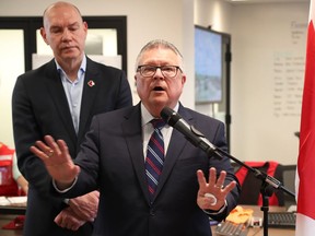 Public Safety and Emergency Preparedness Minister Ralph Goodale speaks with resident Jean Lamoureux as he tours flooded areas in Rockland on Thursday.