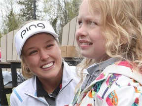 Brooke Henderson talks to young fan Hailey Hewson at the Kevin Haime Kids to the Course Classic at the Eagle Creek Golf Club in Dunrobin on Tuesday.