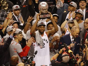 Toronto Raptors Kawhi Leonard SF (2) raises the Eastern Conference champions trophy in Toronto, Ont. on Saturday May 25, 2019.