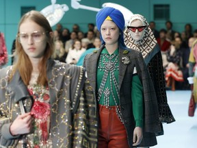 FILE - In this Feb. 21, 2018 file photo, models display items from Gucci's women's Fall/Winter 2018-2019 collection, presented during the Milan Fashion Week, in Milan, Italy. The top civil rights organization for Sikhs in the United States says Nordstrom has apologized to the community for selling an $800 turban they found offensive, but they are still waiting to hear from the Gucci brand that designed it, Saturday, May 18, 2019.