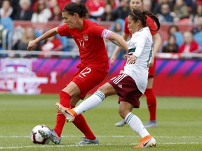 Canada's Christine Sinclair tries to keep the ball away from Mexican midfielder Karla Nieto during the first half of a women's international soccer friendly in Toronto on May 18.