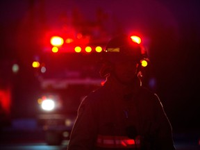 FILE: A firefighter at the scene of a fire.