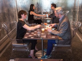 Erin Anderson and Alex Anderson sample their drinks as the small dining room called THRU, which seats only six customers and is located upstairs and at the back of Atelier Restaurant on Rochester Street
