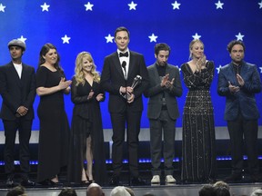 FILE - In this Jan. 13, 2019, file photo, Kunal Nayyar, from left, Mayim Bialik, Melissa Rauch, Jim Parsons, Simon Helberg, Kaley Cuoco and Johnny Galecki, from the cast of "The Big Bang Theory," present the creative achievement award at the 24th annual Critics' Choice Awards at the Barker Hangar in Santa Monica, Calif. Hugs and tears punctuated the final taping of "The Big Bang Theory," a lovefest for its stars, crew and audience alike. There were plenty of punchlines as well, as the true-to-form hit comedy about scientists and those who love them wrapped the two-part, hour-long finale that will air in mid-May on CBS.