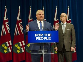 Ontario Premier Doug Ford speaks to reporters with MPP Steve Clark, Minister of Municipal Affairs and Housing, in Toronto, in this file photo.