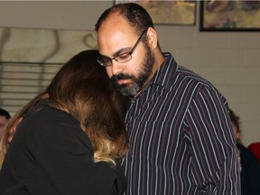 Tammy Poil is comforted by her husband Patrick Reddick Tuesday night at the beginning of a vigil for their daughter Trinity Poil, who's body was discovered in the Ottawa River last Thursday. She had been missing since mid-February.