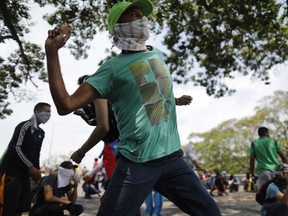 Masked anti-government protesters face off with security forces in Caracas, Venezuela, on Wednesday.